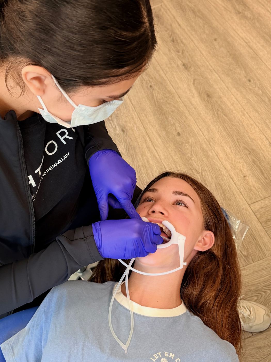 Team member placing braces while a patient rests in the chair